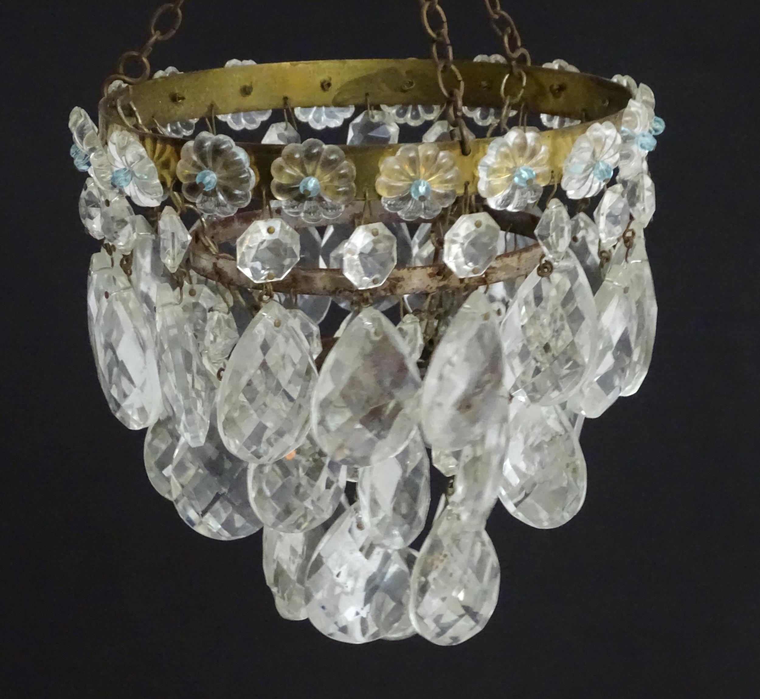 An early 20thC crystal drop bag pendant chandelier, the circular gilt metal mounts supporting - Image 4 of 5