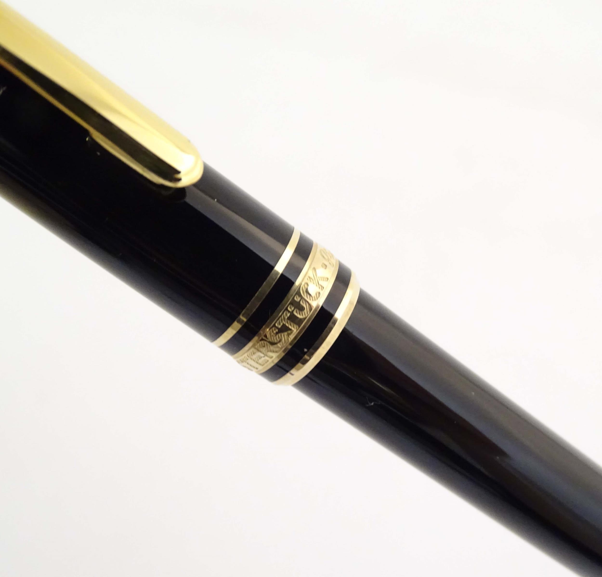 A cased Montblanc 'Meisterstuck' ballpoint pen, in black finish and decorated with gilt banding. - Image 9 of 13