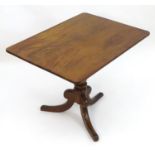 A 19thC mahogany tilt top table with a rectangular top above a turned pedestal base and three