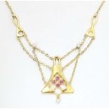 A 14ct gold necklace, the pendant section set with pearls and red stones. The whole approx 19"