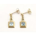 A pair of 9ct gold drop earrings set with aquamarine. Approx. 1/2" long Please Note - we do not make