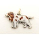 A 9ct gold pendant charm formed as a spaniel dog with enamel detail. Approx. 3/4" long Please Note -