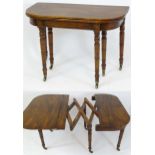 An early 19thC mahogany concertina action dining table with three additional leaves, raised on