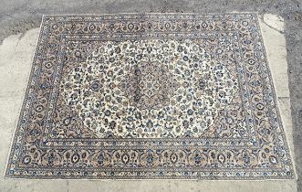 Carpet / Rug : A Kashan carpet with cream / beige ground decorated with floral and folate detail.