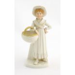 A Royal Worcester figure modelled as a girl with a basket. With printed and impressed marks under.