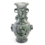 An Oriental jade coloured soapstone vase of three sectional baluster form decorated with stylised
