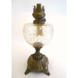 An early 20thC Royal Zanzara oil lamp, the large clear glass reservoir with gold flecked