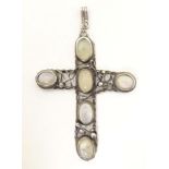 An Arts & Crafts style white metal pendant of cross form set with six water opal style cabochon.
