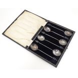 A cased set of six silver coffee spoons the handles surmounted by coffee beans, hallmarked