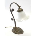 A late 20thC table lamp in the Art Nouveau style with adjustable angle and white glass shade. Approx