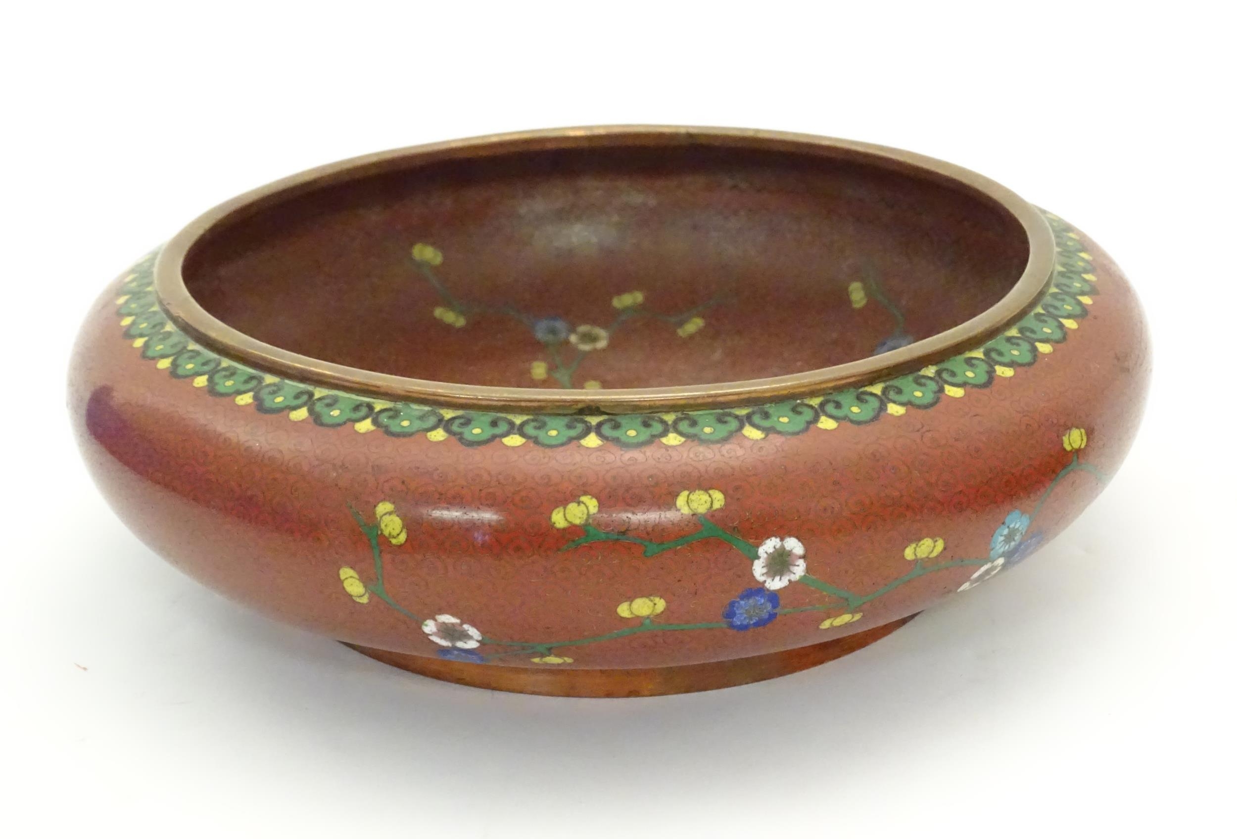 A Chinese cloisonne shallow bowl with floral and foliate detail. Approx. 3 1/4" x 10" diameter