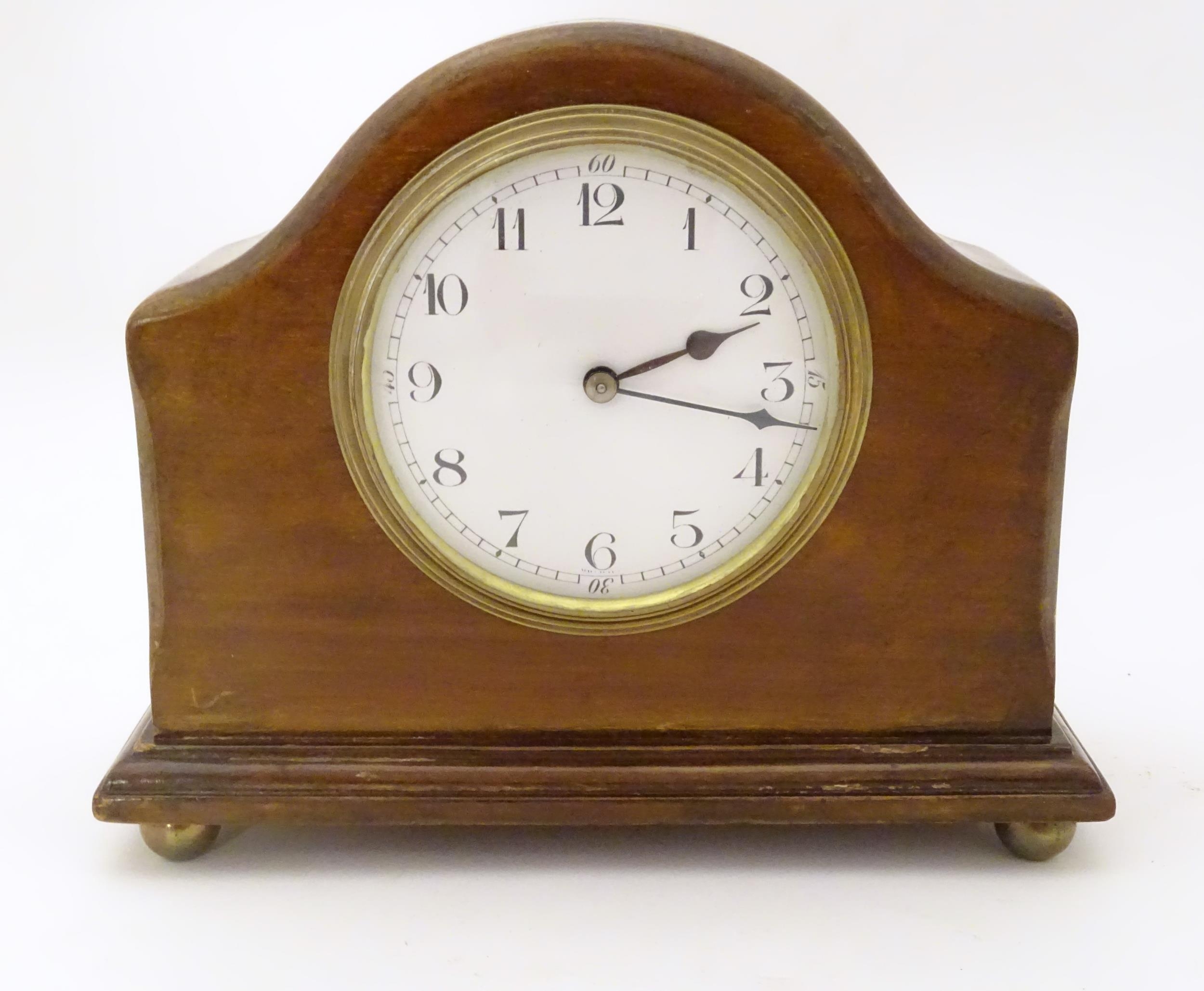 A 20thC mantel clock with French movement. 7 1/2" wide Please Note - we do not make reference to the