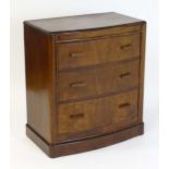 An early / mid 20thC Art Deco walnut chest of drawers with three long drawers and rectangular