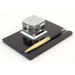 A German Art Deco standish / inkstand with central glass inkwell of square form and dipping pen.