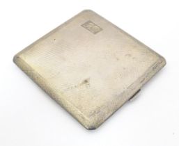A silver cigarette case with engine turned decoration and gilded interior, hallmarked Birmingham
