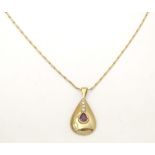 A 9ct gold pendant and chain the pendant of drop form set with ruby and diamonds. Approx 1" long.