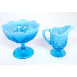 A Davidson blue glass cream jug and pedestal sugar bowl. The bowl 5 1/4" high x 6" diameter Please