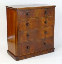 A large Victorian mahogany chest of drawers with a moulded top above two short over three long
