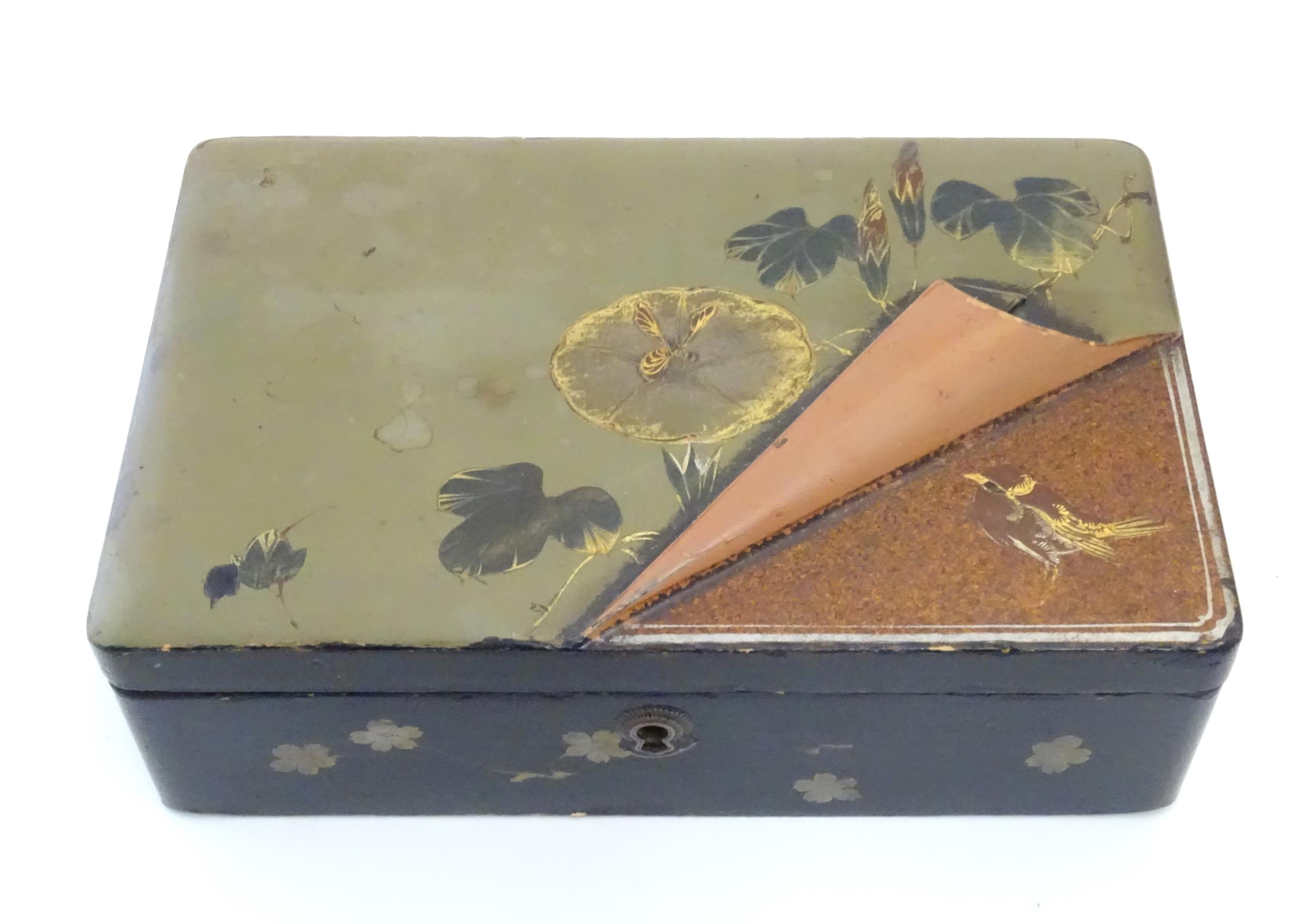 A Japanese lacquered box with hinge lid decorated with flowers and foliage, with faux lifted - Image 2 of 5