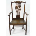 A late 18thC ash and elm Chippendale elbow chair with a shaped top rail above a pierced vase