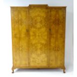 An early / mid 20thC 'Waring and Gillow' wardrobe with burr walnut veneers, cross banded detailing
