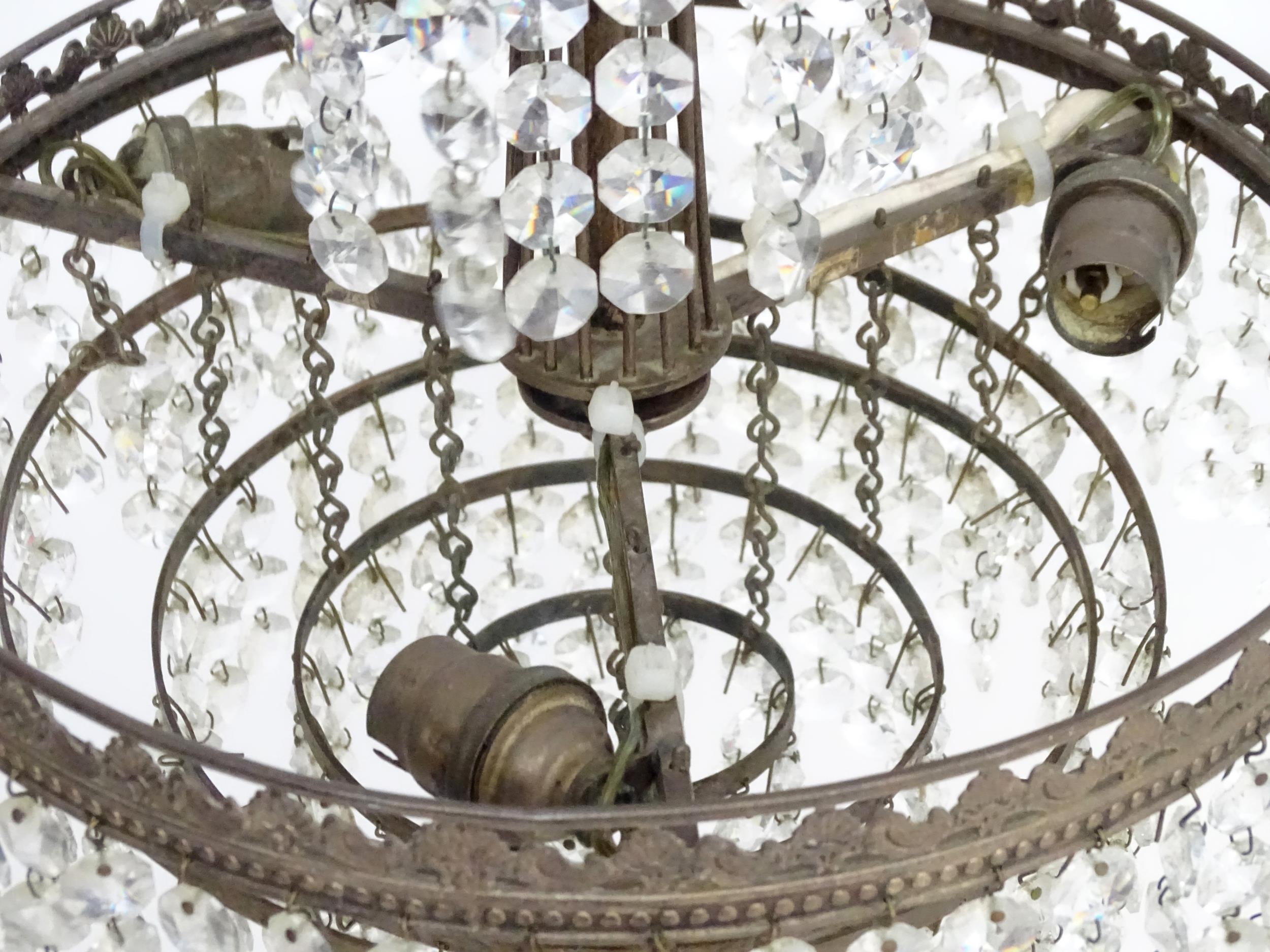 An early 20thC crystal drop bag pendant ceiling light, the chain supporting brass mounts with a - Image 6 of 8