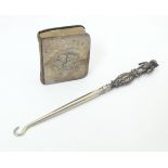 A silver button hook the handle formed as a bear hallmarked Birmingham 1909, maker Adie Lovekin Ltd.