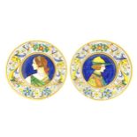 Two Italian majolica portrait plates with folate and mask detail to borders. Signed under S Volpi,
