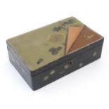 A Japanese lacquered box with hinge lid decorated with flowers and foliage, with faux lifted