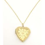 A 9ct gold pendant locket of heart form by Georg Jensen Ltd. With 9ct gold chain 18" long. the
