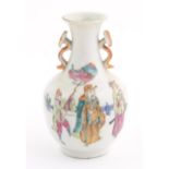 A small Chinese famille rose vase with twin handles of ruyi sceptre form, the body decorated with