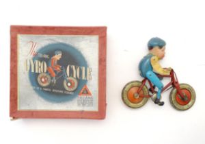 Toy: An early 20thC Lines Brothers / Tri-Ang Gyro Cycle, with a tinplate bicycle and celluloid rider