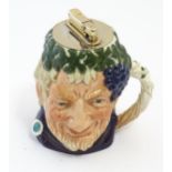 An unusual Royal Doulton Bacchus character jug with Colibri table lighter to top. Approx. 4 1/2"