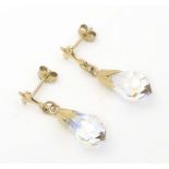 A pair of 9ct gold drop earrings set with facet cut stones. Approx. 1" long Please Note - we do
