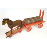Toy: An early 20thC toy horse and cart / dray with eight barrels. Approx 26 1/2" wide x 7 5/8" deep,