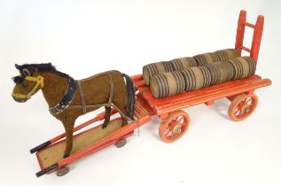 Toy: An early 20thC toy horse and cart / dray with eight barrels. Approx 26 1/2" wide x 7 5/8" deep,