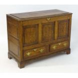 An 18thC and later oak mule chest with a moulded lid above three crossbanded panels to the front and