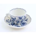A Meissen blue and white cup and saucer in the onion pattern. With blue crossed sword mark under.