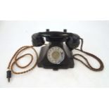 A c1930s GPO 232L telephone, of Bakelite construction with black finish, the receiver stamped 'PL-43