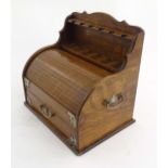 An early 20thC oak smokers companion / box with silver plate mounts, tambour front with a single