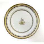 A Chinese Export plate with long dog armorial and monogram under, with gilt leaf border. Approx. 7