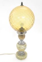 A mid 20thC table lamp, the upstand consisting of three onyx graduated roundels affixed to chromed