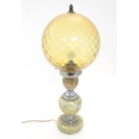 A mid 20thC table lamp, the upstand consisting of three onyx graduated roundels affixed to chromed