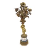 A late 19thC French cast gilt metal candelabra / candelabrum formed as cherub holding aloft floral