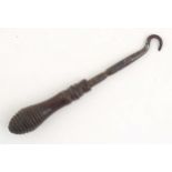 A Victorian button hook with a turned wooden handle. Approx. 4 1/2" long Please Note - we do not