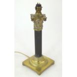 An early 20thC table lamp formed as a corinthian column, of brass construction and standing on a