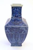 A Chinese blue and white vase of squared form decorated with stylised masks, banded detail and