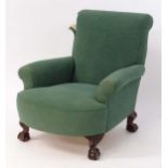 A Green Howard style armchair raised on short acanthus carved cabriole legs terminating in ball