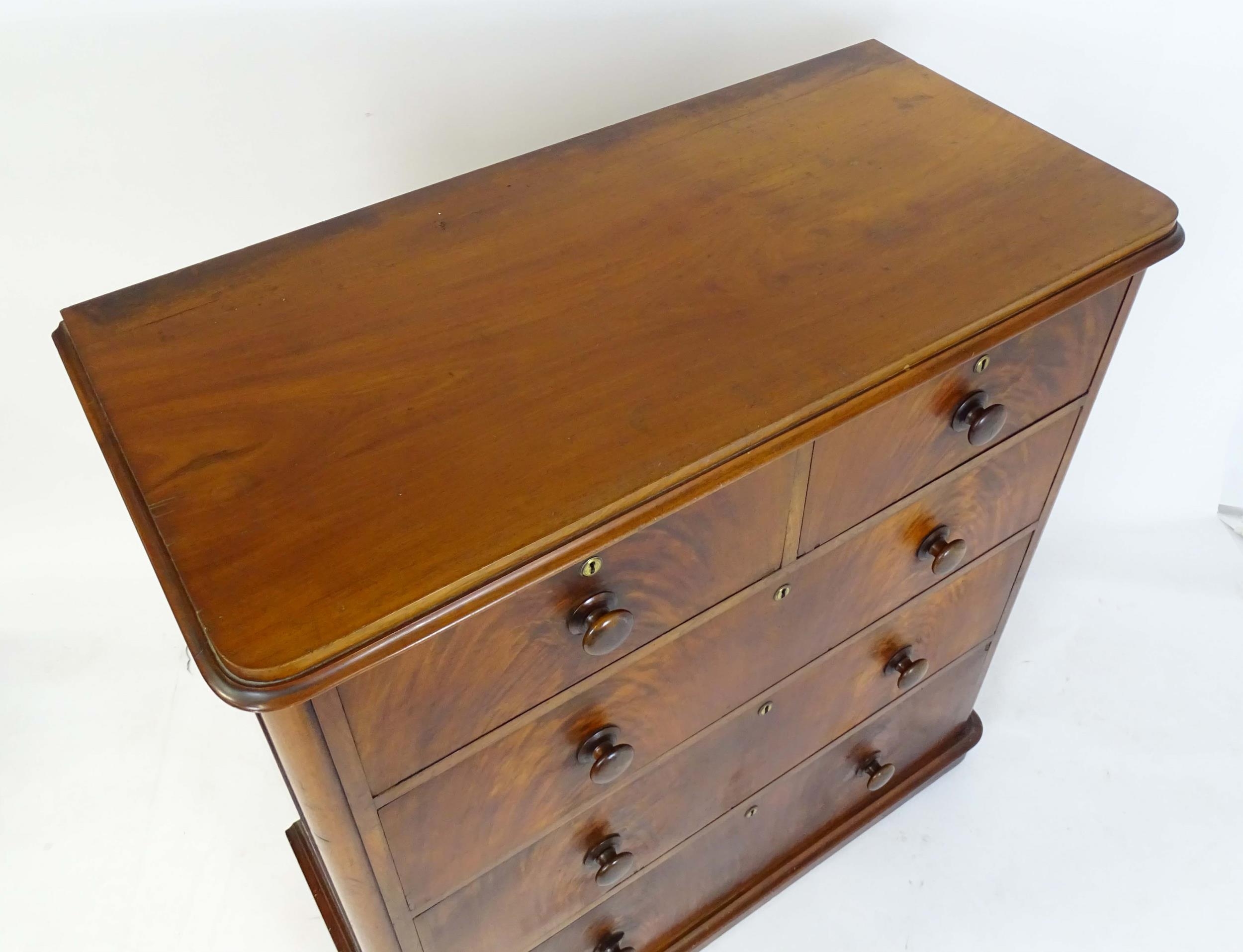 A large Victorian mahogany chest of drawers with a moulded top above two short over three long - Image 5 of 13