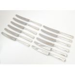 A set of six silver handled knives hallmarked Sheffield 1975, maker Henry Hutton & Co. Together with